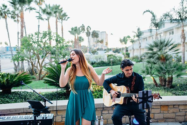 girl singing with man playing guitar