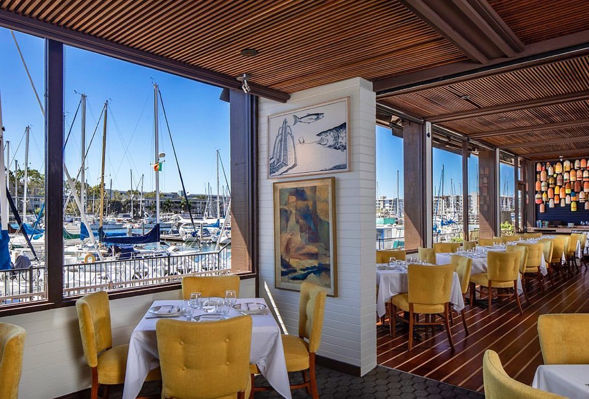 MDR restaurant Dear Jane's windows looking out to harbor and boats