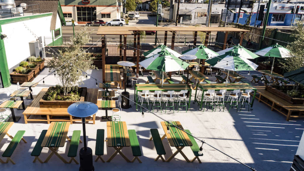 Restaurant dining patio with umbrellas, benches and chairs