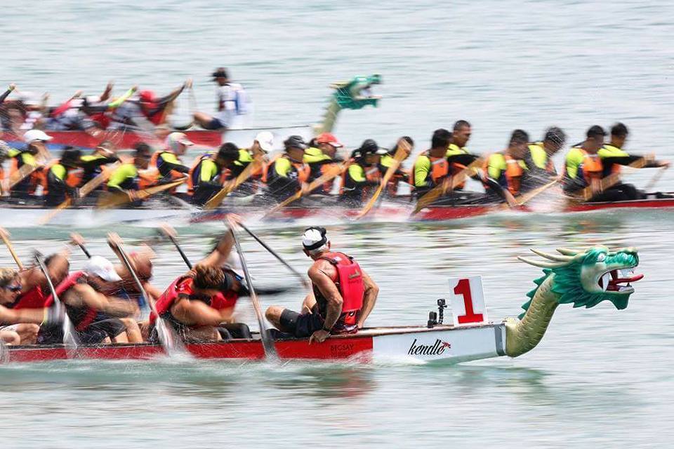 Dragon boats racing on the ocean