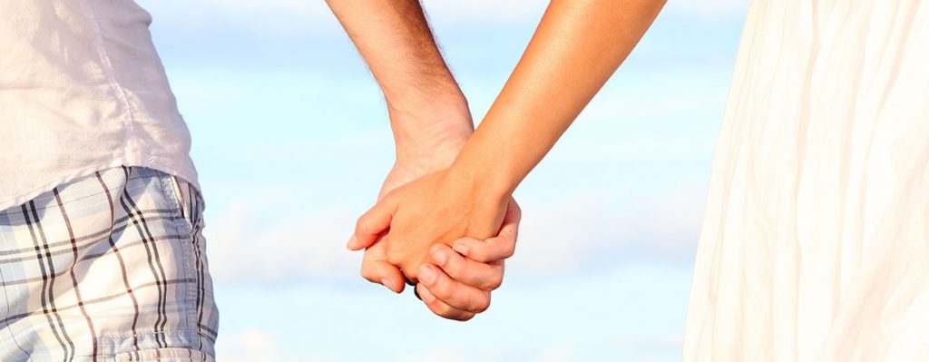 holding hands at the beach