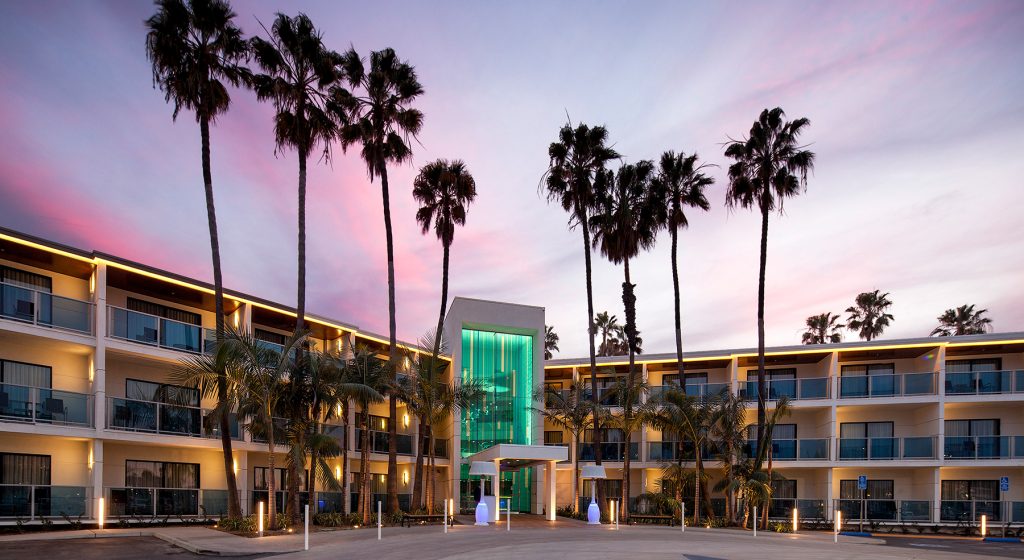 palm trees in front of hotel entrance