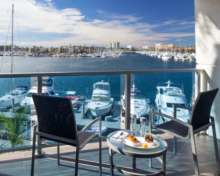 breakfast served on a balcony overlooking boats in marina