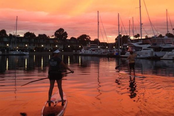 paddle boarding at sunset