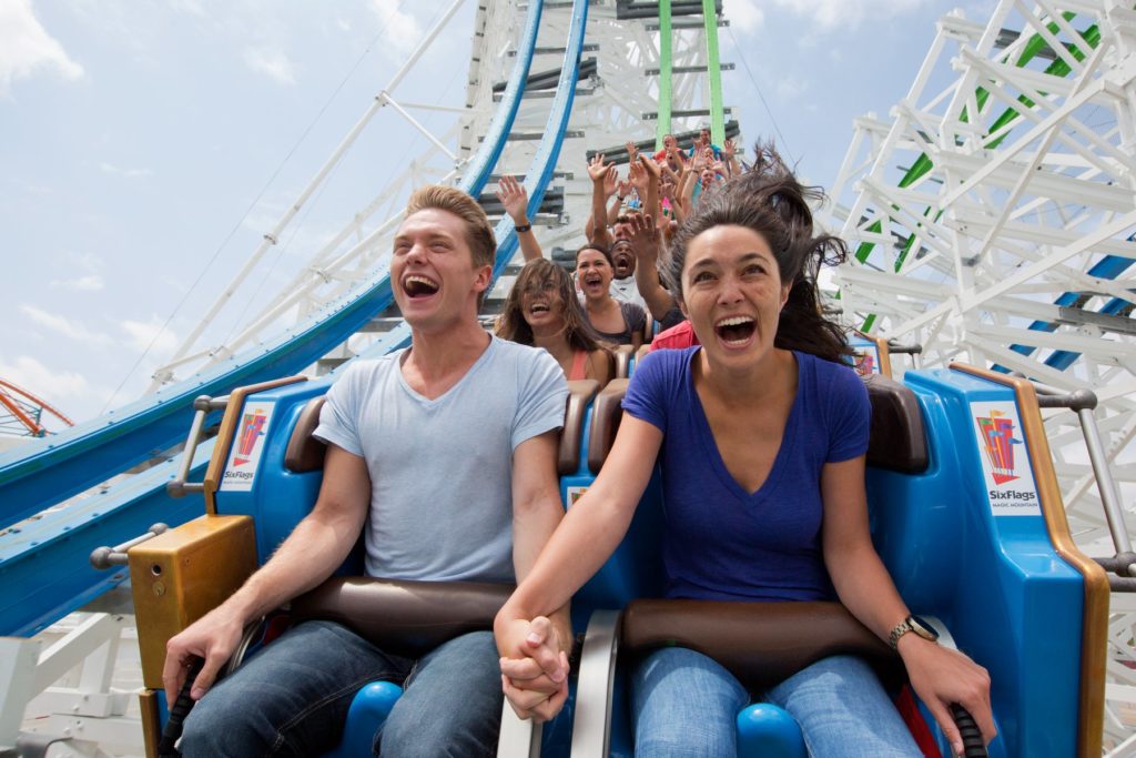 People shouting while riding roller coaster ride at Six Flags Magic Mountain Los Angeles