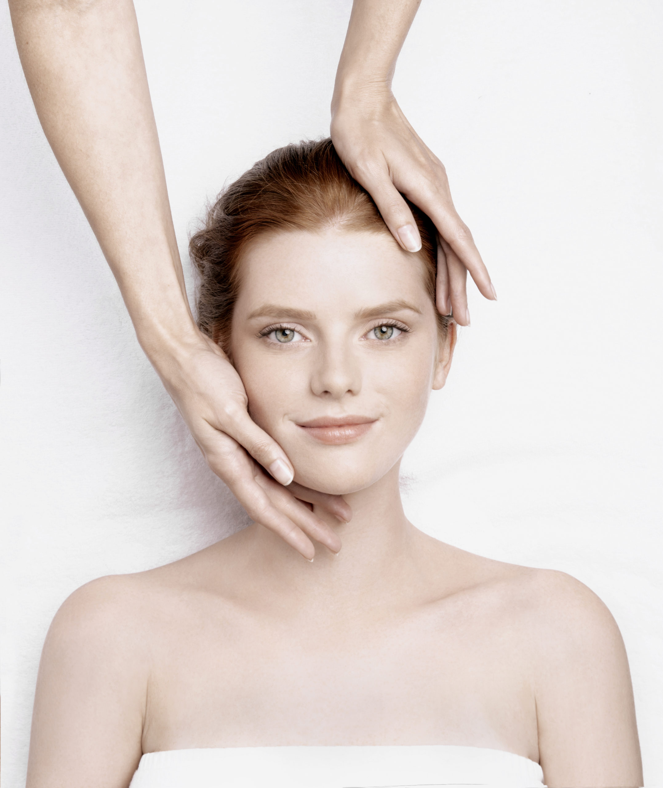 woman getting massage on her head and face