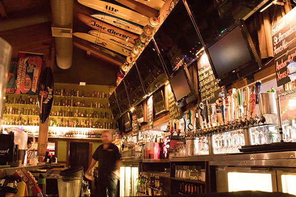 beer taps and bottles in bar