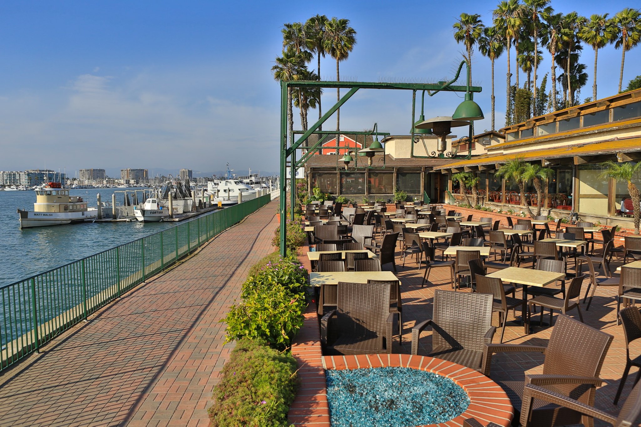 Restaurant outdoor patio along promenade overlooking harbor