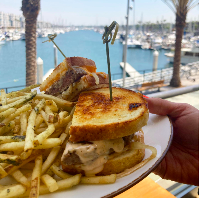 plate of fries and patty melt sandwich outside